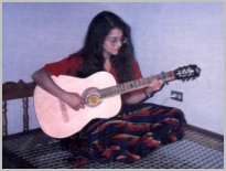 Photo of Lori playing guitar